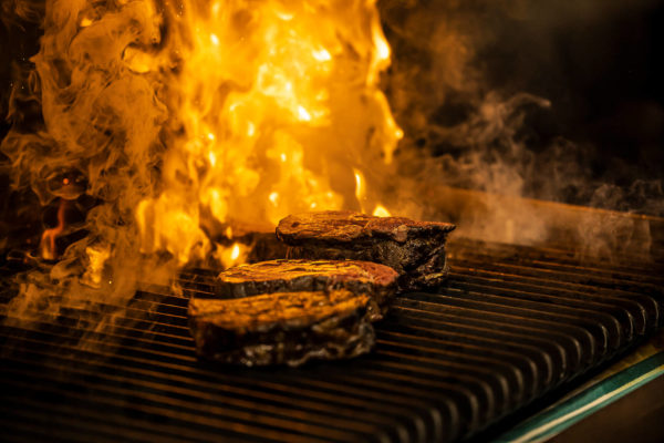 Steaks cooking on grill