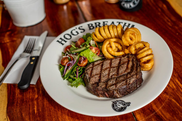 Prime Rib Steak with curly fries and salad