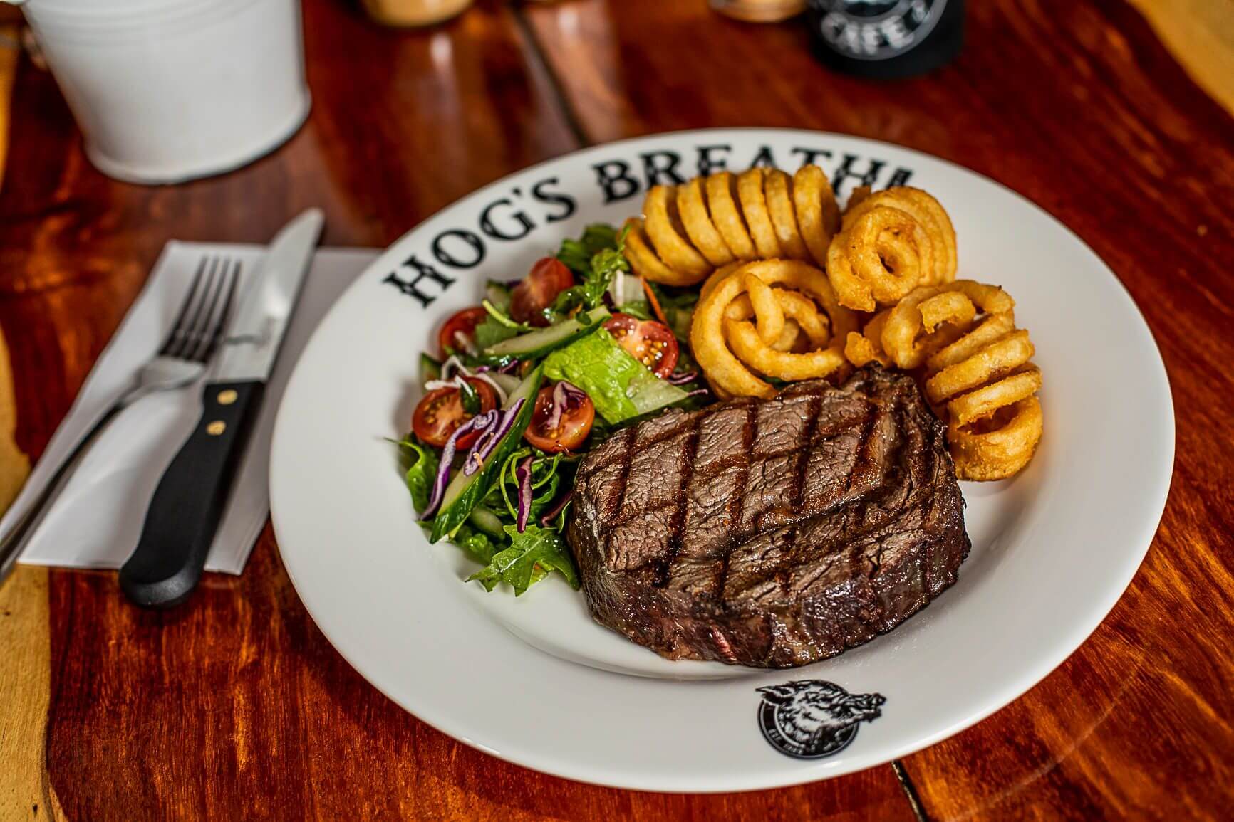 Prime Rib Steak with Curly Fries and salad